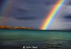 This is a Rainbow over Torch Lake, in Michigan. The fall ... by John Peal 